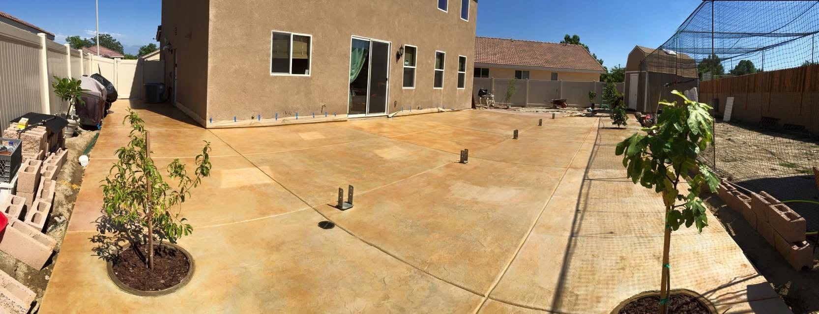 Freshly poured stamped concrete patio in Colton backyard