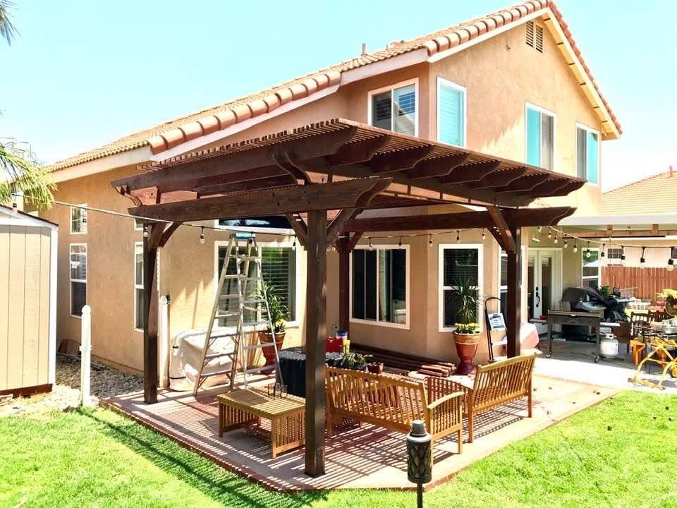 Finished covered patio with wood beams and seating